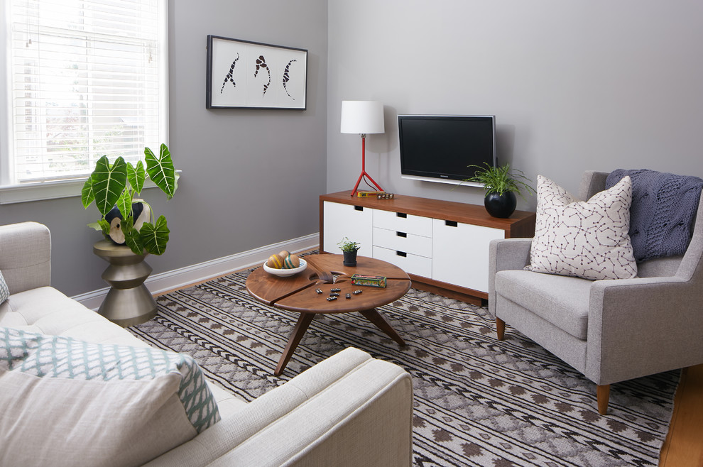 Design ideas for a small modern open plan living room in Charleston with grey walls and medium hardwood flooring.