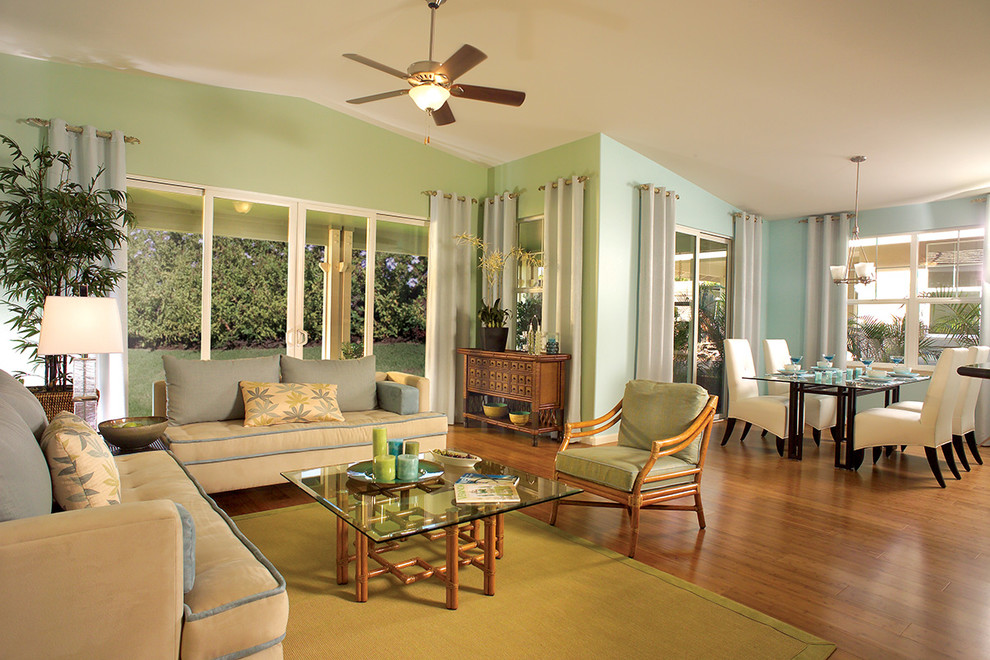 Trendy open concept medium tone wood floor living room photo in Hawaii with green walls