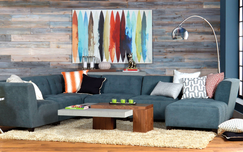 Immagine di un soggiorno bohémian di medie dimensioni e chiuso con pareti blu, pavimento in legno massello medio, nessun camino e nessuna TV
