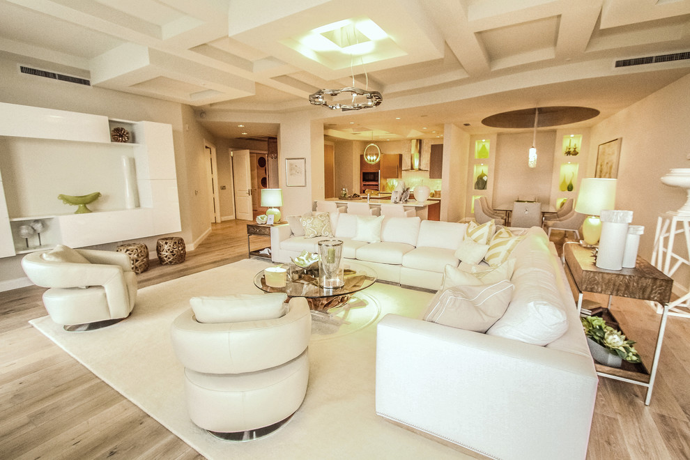 Inspiration for a traditional living room in Miami with white walls and light hardwood flooring.