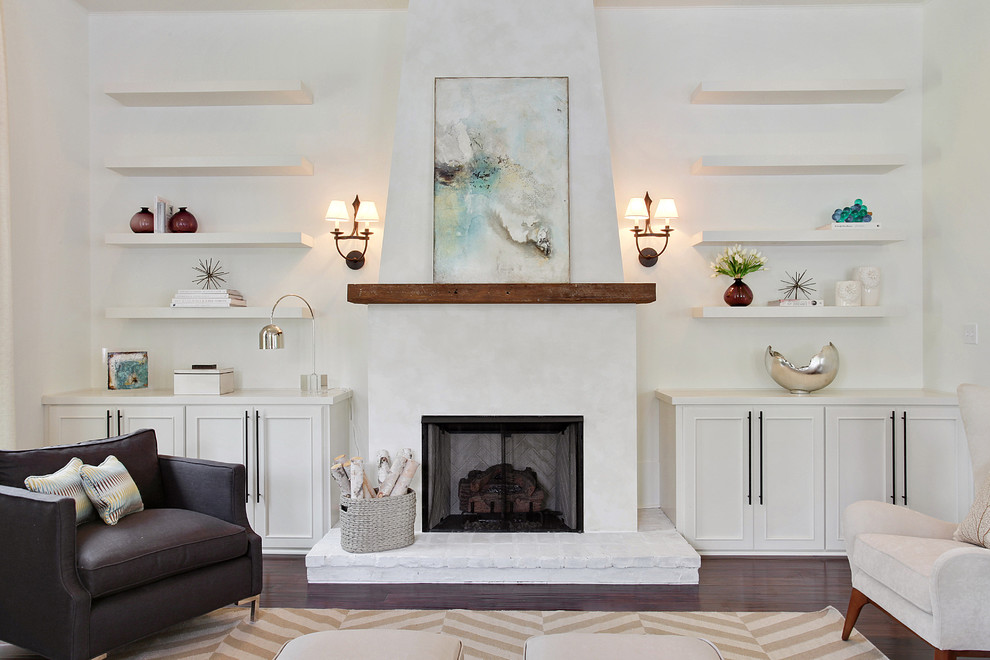 This is an example of a contemporary living room in New Orleans with white walls, a standard fireplace and feature lighting.