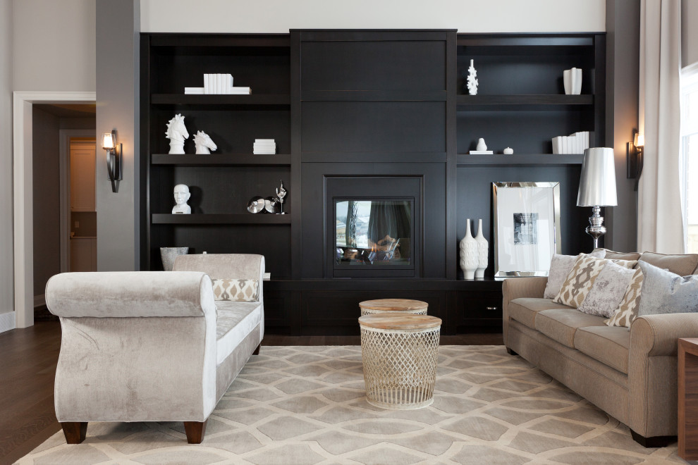 Photo of a medium sized classic open plan living room in Toronto with beige walls, medium hardwood flooring, a standard fireplace and brown floors.