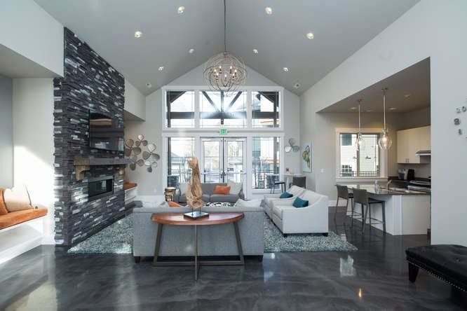 Medium sized traditional open plan living room in Seattle with grey walls, concrete flooring, a ribbon fireplace, a stone fireplace surround, a wall mounted tv and grey floors.