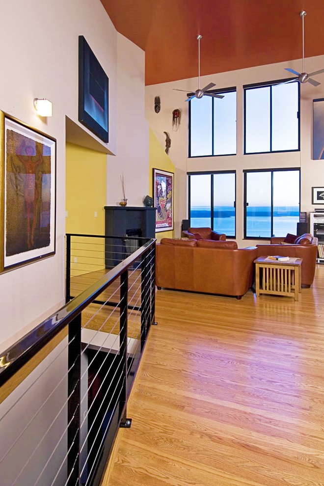 This is an example of a medium sized modern formal living room in Seattle with multi-coloured walls and light hardwood flooring.