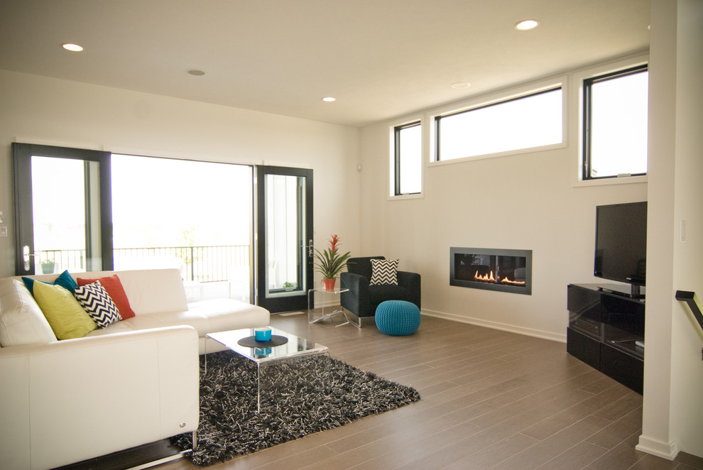 Photo of a modern living room in Grand Rapids with a standard fireplace.
