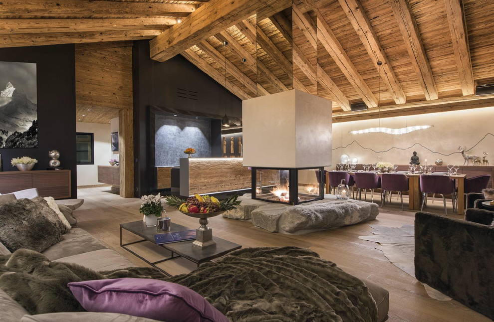 Foto di un grande soggiorno design aperto con sala formale, camino bifacciale, cornice del camino in pietra e nessuna TV