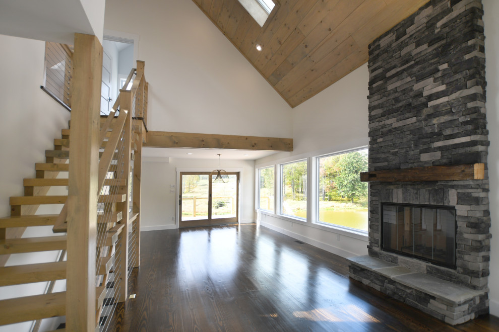 Mid-sized country open concept dark wood floor and brown floor living room photo in New York with white walls, a standard fireplace and a stone fireplace