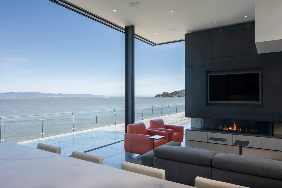 Large minimalist open concept and formal concrete floor and gray floor living room photo in San Francisco with gray walls, a ribbon fireplace, a metal fireplace and a wall-mounted tv
