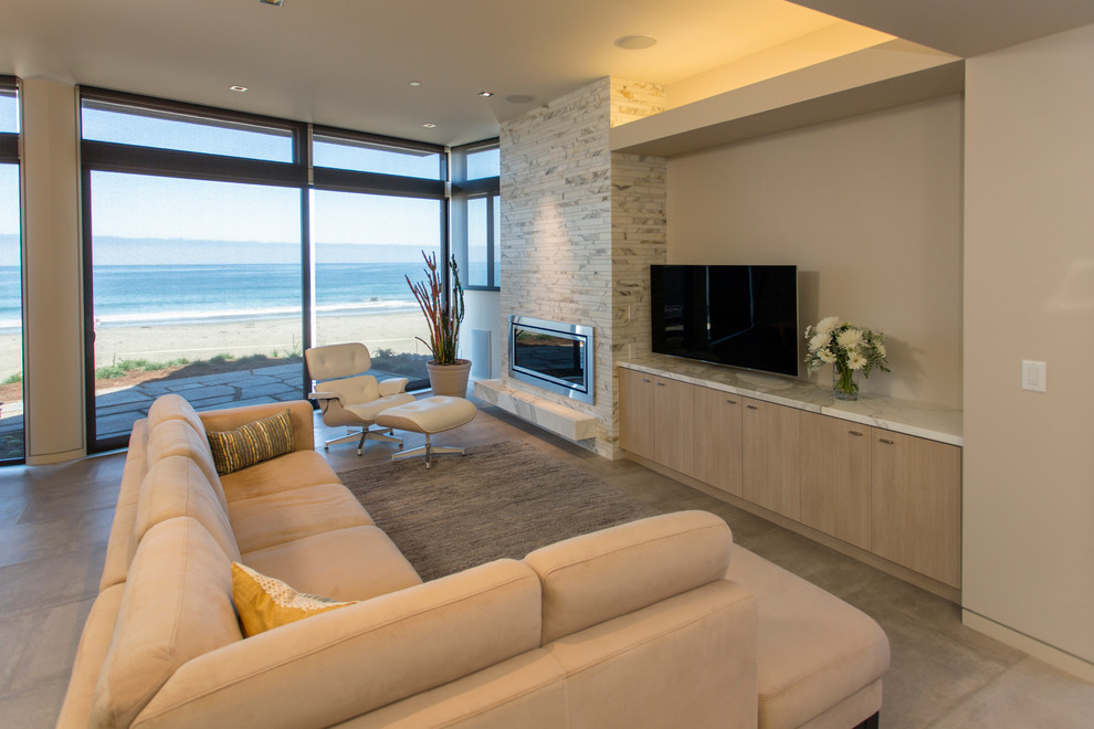 Photo of a modern open plan living room in San Luis Obispo with a stone fireplace surround.