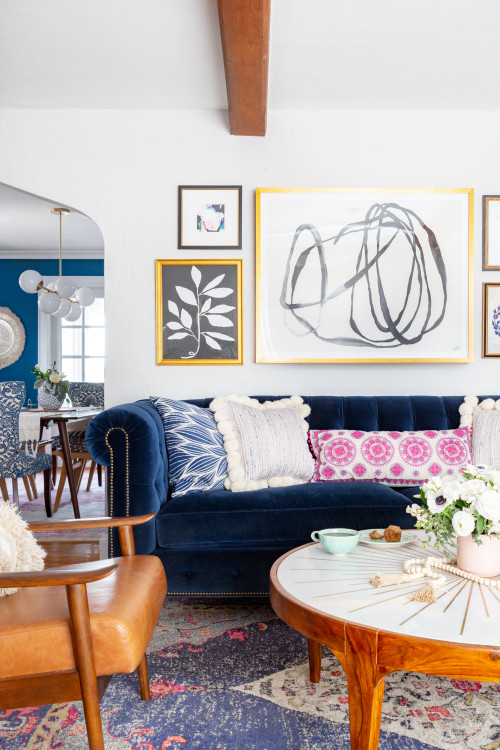 boho inspired living room featuring a dark blue velvet couch