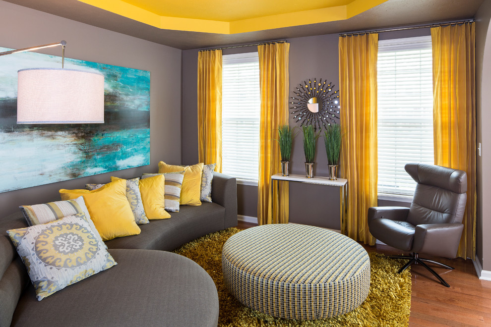 Contemporary grey and yellow living room in Indianapolis with grey walls.