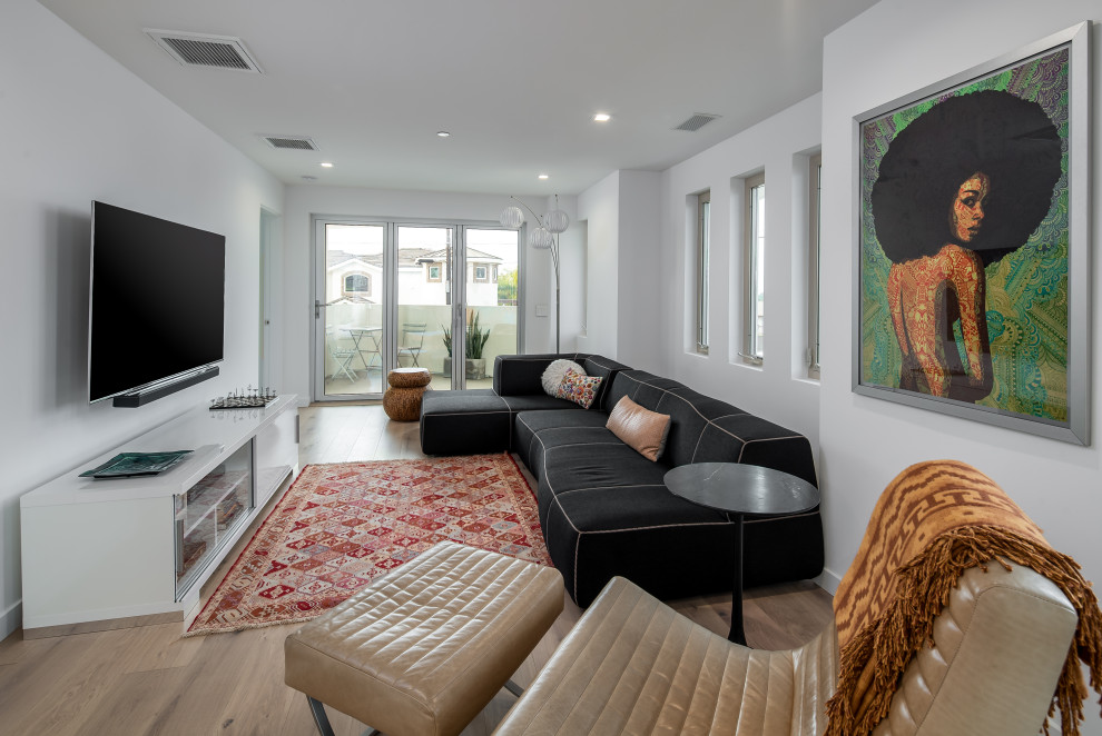 Photo of a small contemporary formal open plan living room in San Diego with white walls, light hardwood flooring, no fireplace, no tv and brown floors.