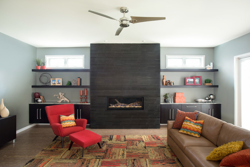 This is an example of a modern living room in Chicago with a ribbon fireplace and grey walls.
