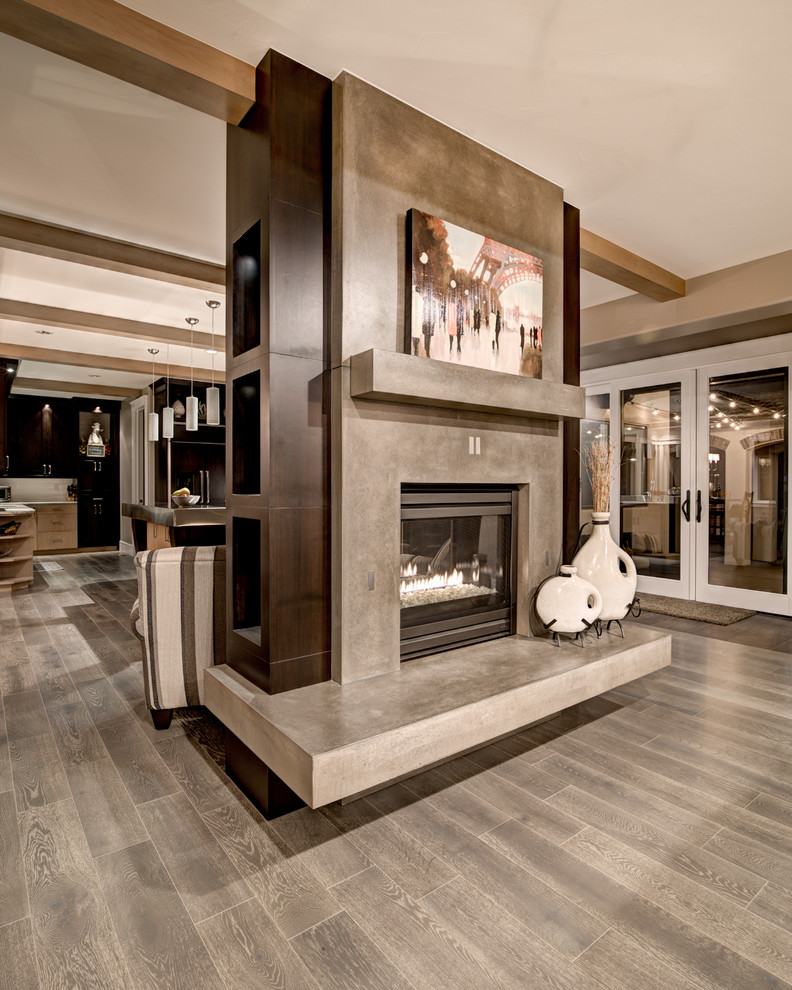 Inspiration for a large contemporary formal open plan living room in Denver with beige walls, medium hardwood flooring, a two-sided fireplace, a concrete fireplace surround and a built-in media unit.