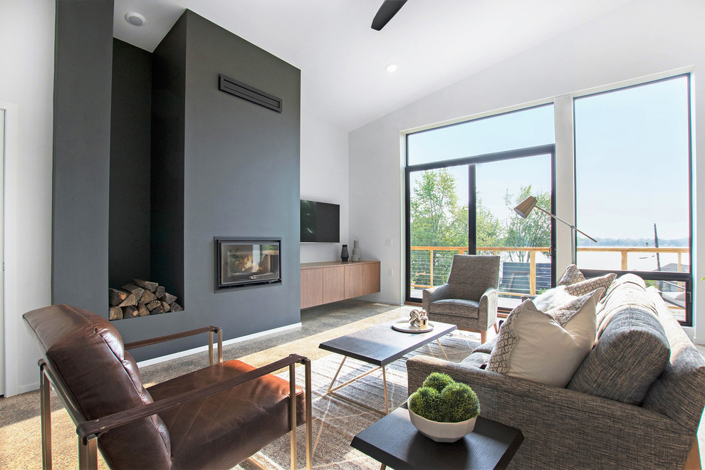 Идея дизайна: большая парадная, открытая гостиная комната в стиле модернизм с серыми стенами, темным паркетным полом, стандартным камином, фасадом камина из бетона и коричневым полом без телевизора