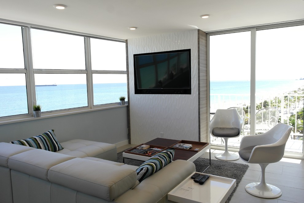 Mid-sized minimalist open concept porcelain tile living room photo in Miami with white walls and a media wall