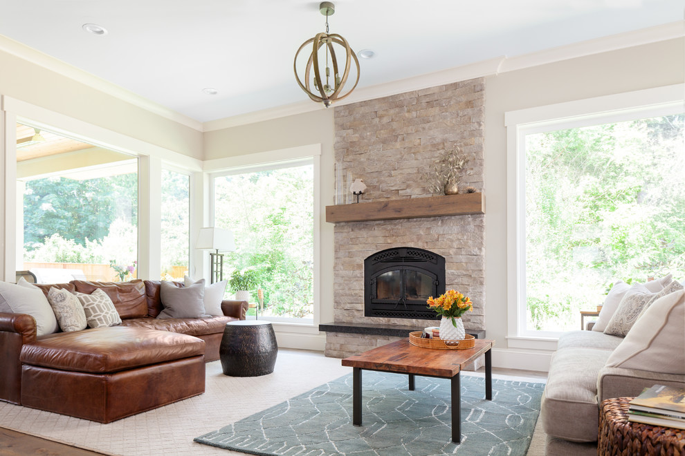 Inspiration for a mid-sized rustic open concept medium tone wood floor and brown floor living room remodel in Seattle with gray walls, a standard fireplace, a stone fireplace and no tv