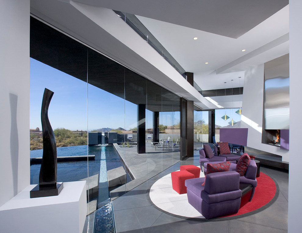 Large modern formal open plan living room in Phoenix with a standard fireplace, a metal fireplace surround, white walls, concrete flooring, no tv and grey floors.