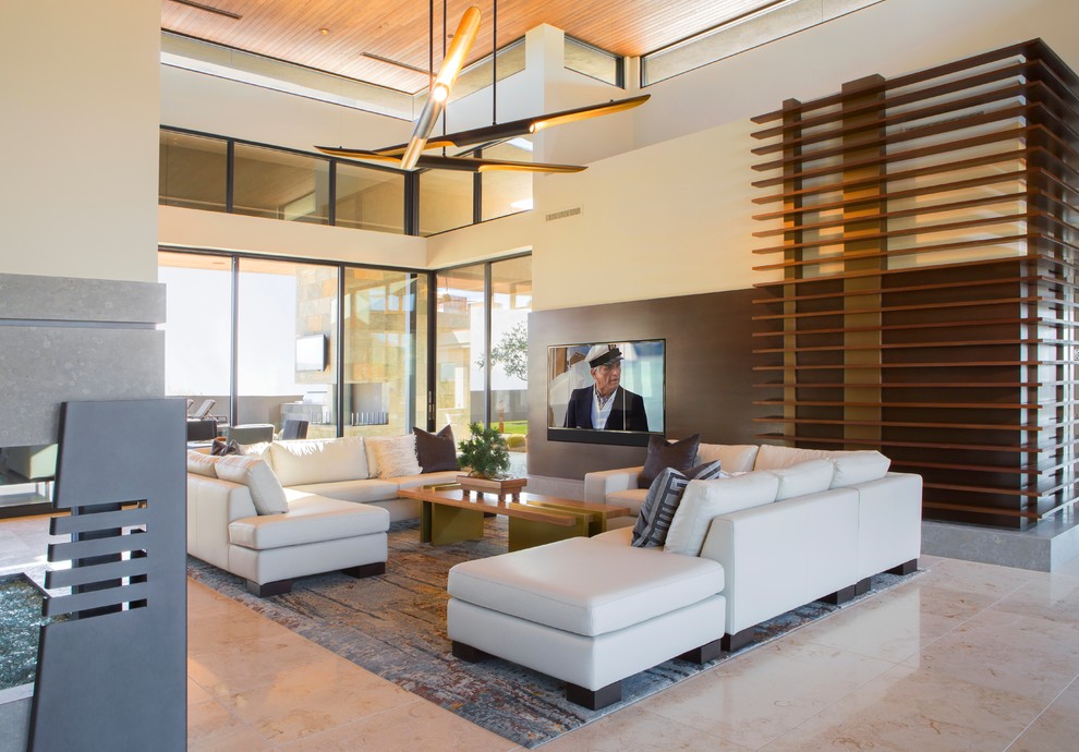 Example of a large trendy formal and open concept limestone floor and beige floor living room design in Phoenix with beige walls, a hanging fireplace and a metal fireplace