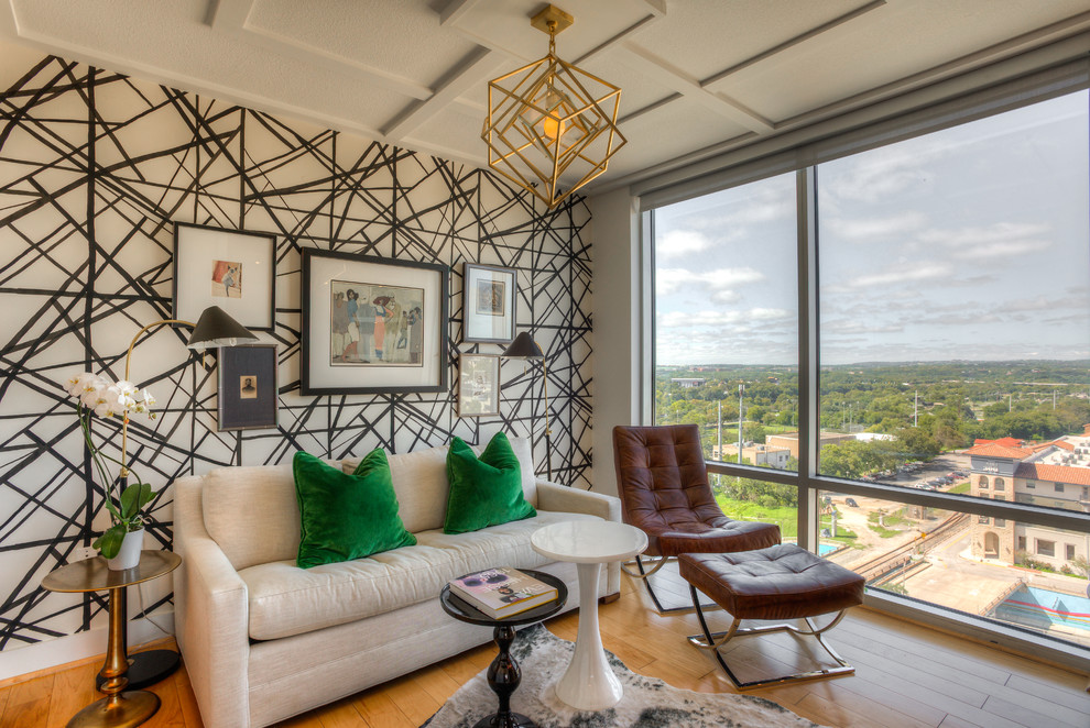 Trendy medium tone wood floor and brown floor living room photo in Austin with white walls and no fireplace