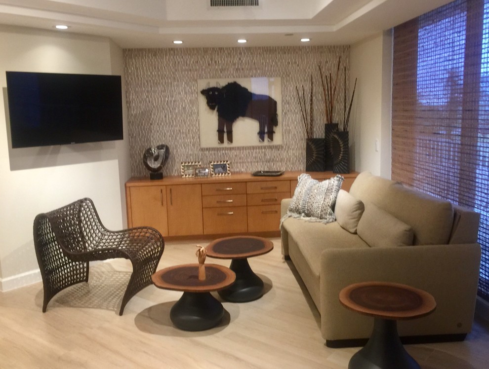 Small contemporary open plan living room in Miami with grey walls, light hardwood flooring, no fireplace, a wall mounted tv and beige floors.