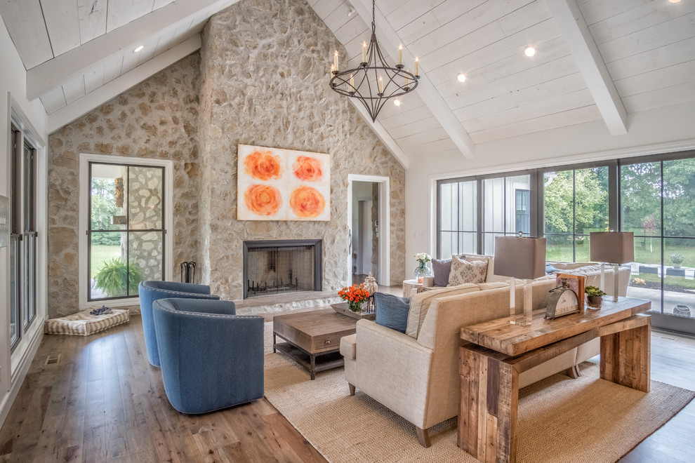 Photo of a large eclectic open plan living room in Other with white walls, medium hardwood flooring, a standard fireplace, a stone fireplace surround and a wall mounted tv.
