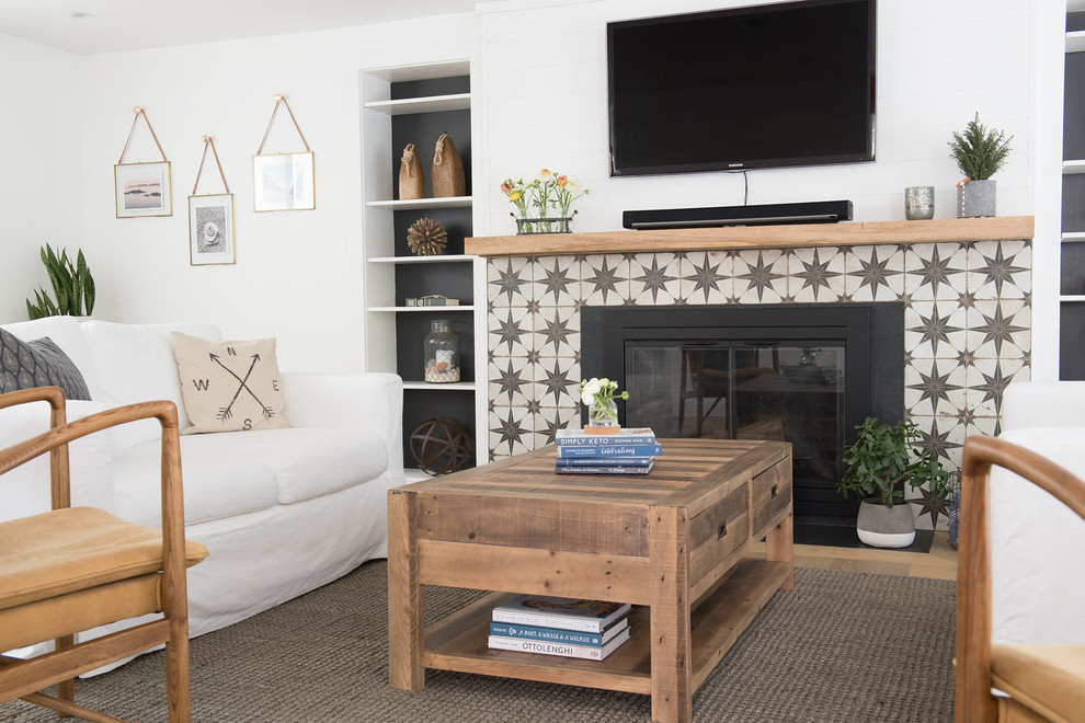 Inspiration for a large country open concept light wood floor and brown floor living room remodel in Boston with white walls, a standard fireplace, a concrete fireplace and a wall-mounted tv