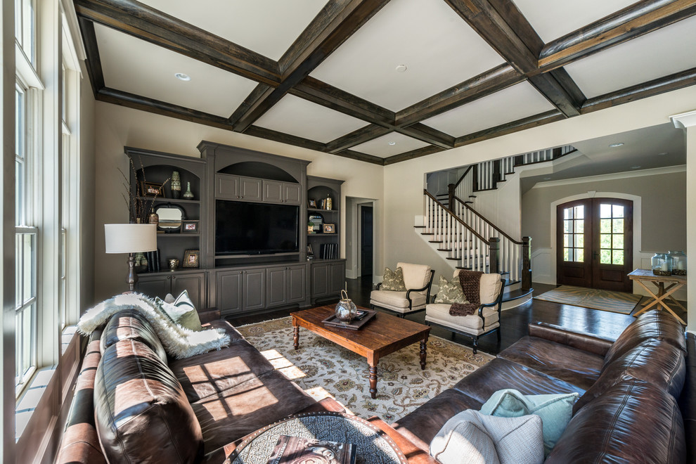 This is an example of a medium sized rural open plan living room in Atlanta with beige walls, dark hardwood flooring, a standard fireplace, a stone fireplace surround and a built-in media unit.