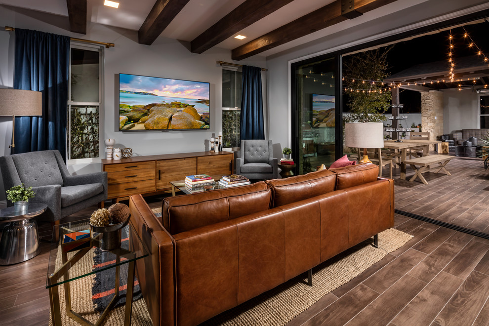Traditional living room in Los Angeles with grey walls, dark hardwood flooring and a wall mounted tv.
