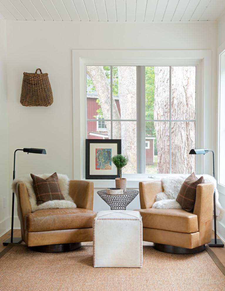 Example of a farmhouse medium tone wood floor living room design in New York with white walls, no fireplace and no tv