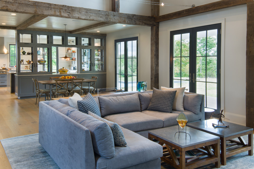 Inspiration for a large country open concept light wood floor living room remodel in New York with gray walls