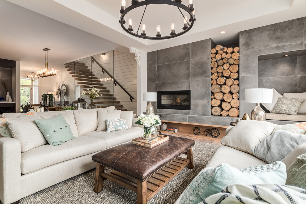 Großes, Offenes Landhausstil Wohnzimmer mit weißer Wandfarbe, hellem Holzboden, gefliester Kaminumrandung, beigem Boden und Kamin in Calgary