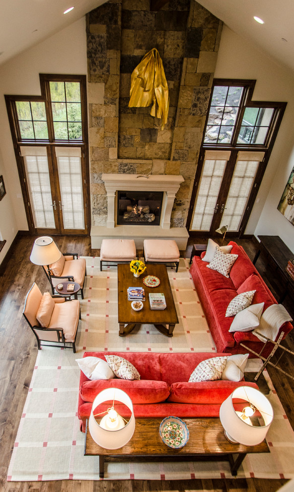 This is an example of a large country open plan living room in Denver with beige walls, medium hardwood flooring, a standard fireplace and a stone fireplace surround.