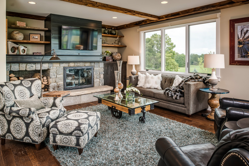 Inspiration for a farmhouse open concept dark wood floor and brown floor living room remodel in Other with a bar, beige walls, a standard fireplace, a stone fireplace and a media wall