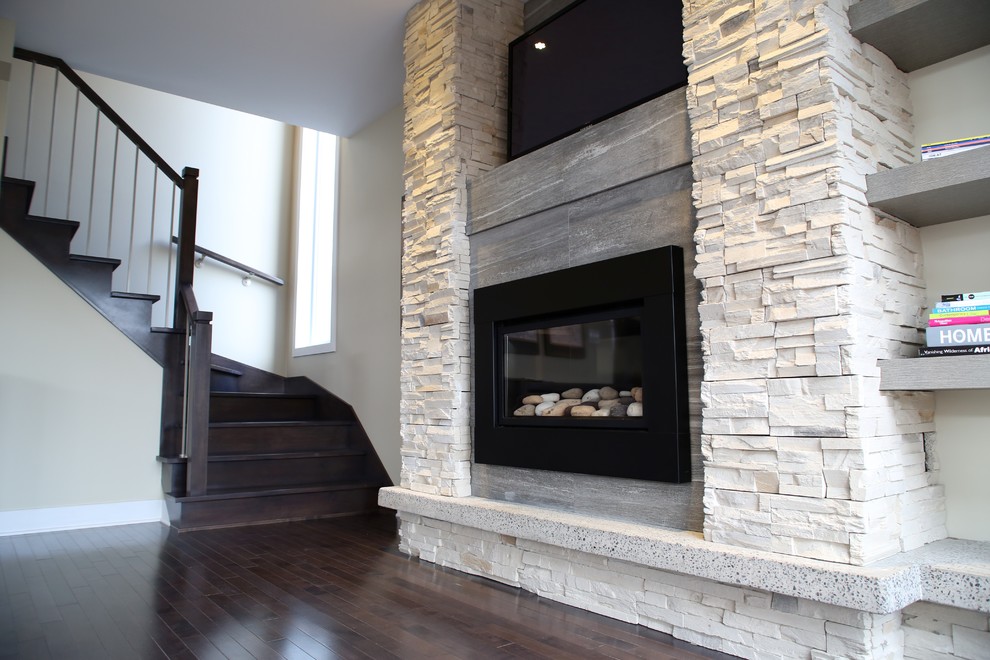 Photo of a large modern open plan living room in Montreal with beige walls, dark hardwood flooring, a standard fireplace, a tiled fireplace surround and a built-in media unit.