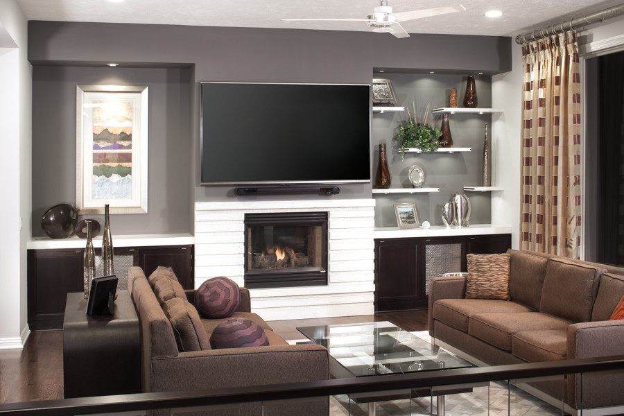 Example of a mid-sized minimalist open concept dark wood floor living room design in Omaha with gray walls, a standard fireplace, a concrete fireplace and a wall-mounted tv