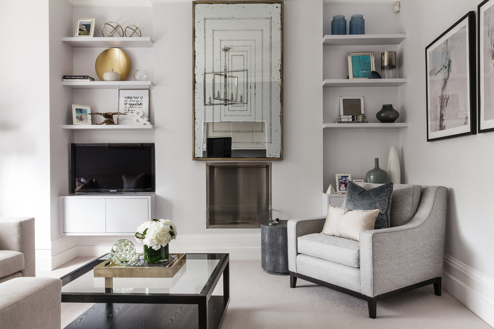 Photo of a traditional grey and cream living room in London with carpet, a standard fireplace, a built-in media unit and grey walls.