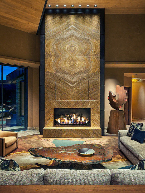 Example of a huge trendy open concept limestone floor living room design in Phoenix with beige walls, a standard fireplace, a stone fireplace and a wall-mounted tv