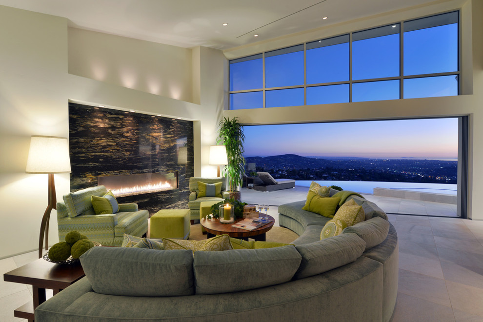 Modern living room in San Diego with beige walls, a ribbon fireplace and feature lighting.