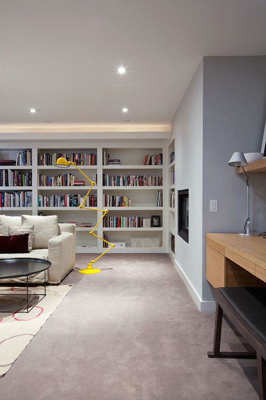 Example of a large 1950s carpeted living room library design in Toronto with a ribbon fireplace