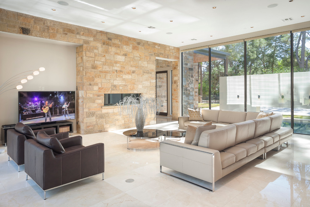 This is an example of a modern formal enclosed living room in Houston with a ribbon fireplace, a stone fireplace surround and a freestanding tv.