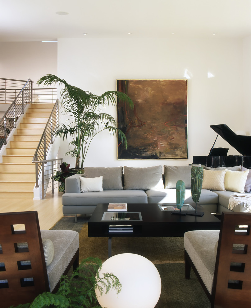 Inspiration for a large modern open concept light wood floor and beige floor living room remodel in San Francisco with a music area, beige walls, a standard fireplace, a concrete fireplace and no tv