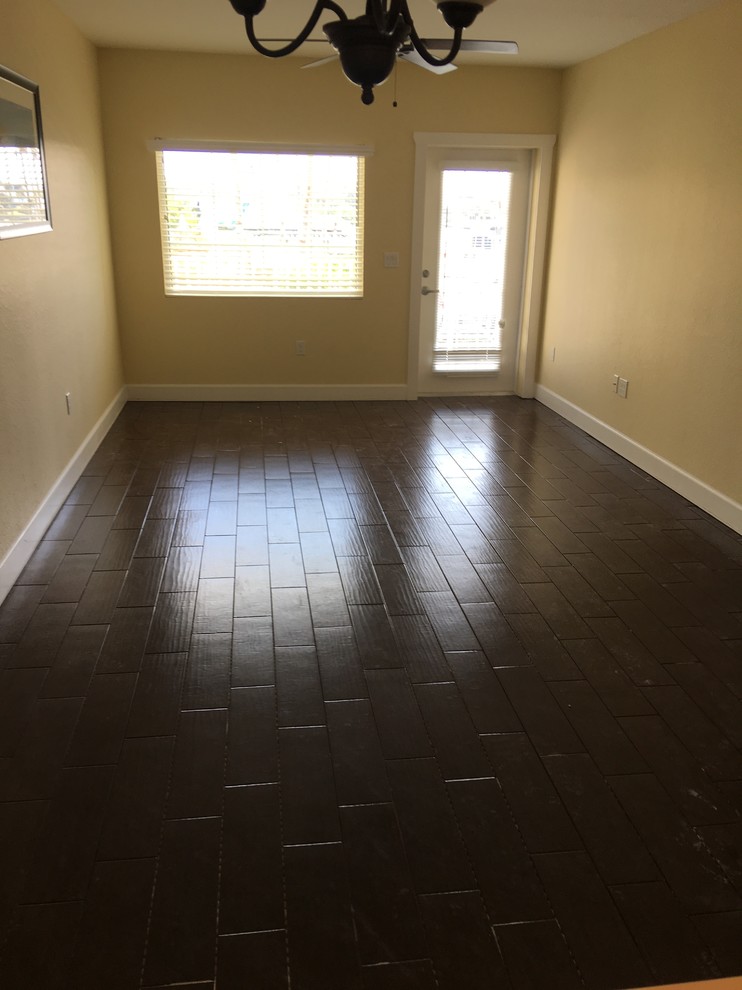 Medium sized classic formal enclosed living room in Tampa with yellow walls, dark hardwood flooring and no tv.
