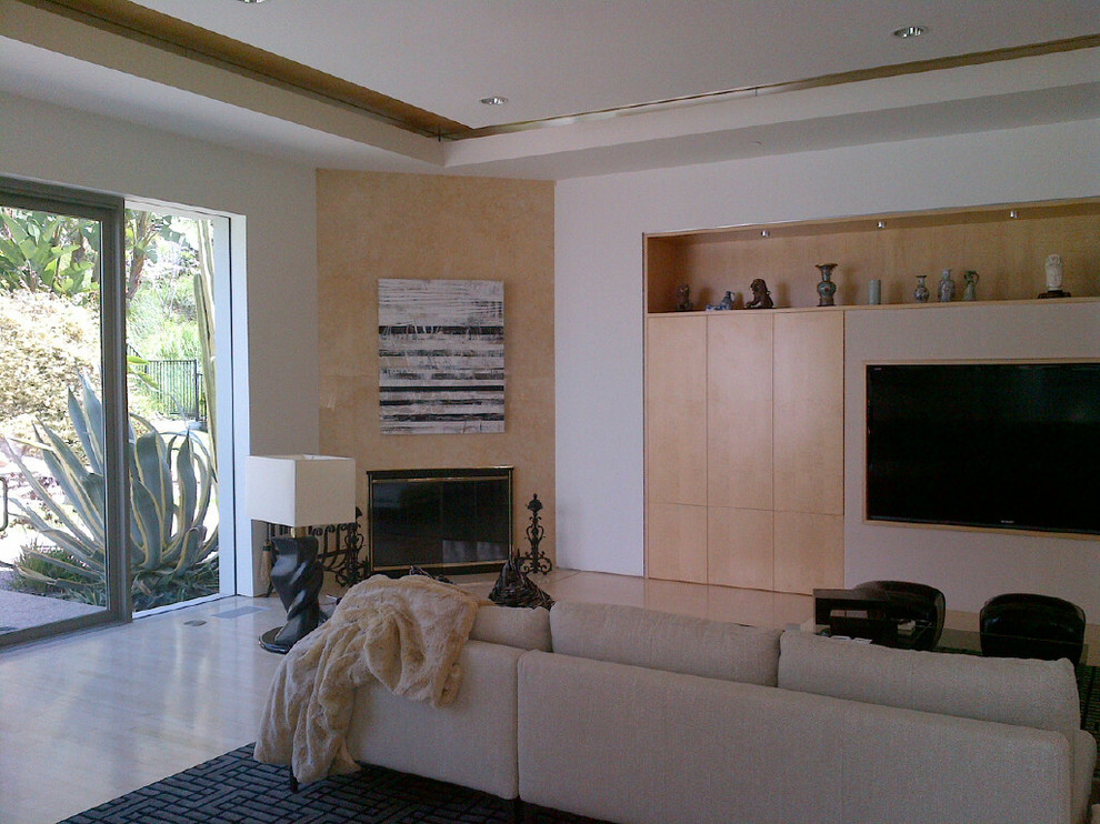 Large contemporary living room in Los Angeles with white walls, limestone flooring, a corner fireplace, a stone fireplace surround and a built-in media unit.