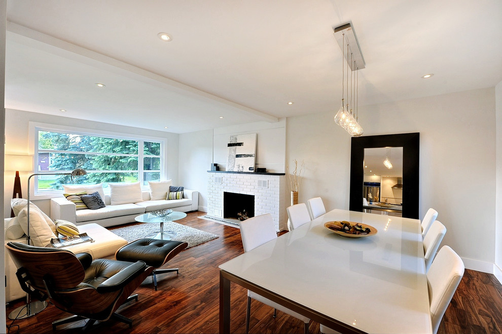 Modern living room in Montreal with white walls, a standard fireplace and a brick fireplace surround.