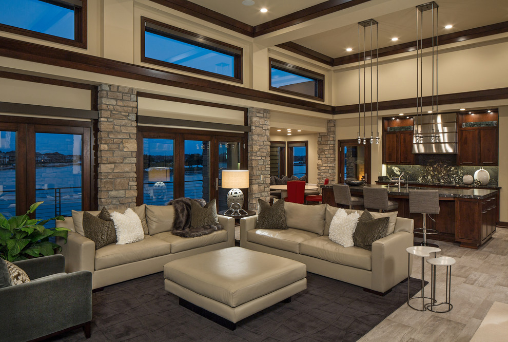 Large contemporary open plan living room in Omaha with beige walls, porcelain flooring and a wall mounted tv.