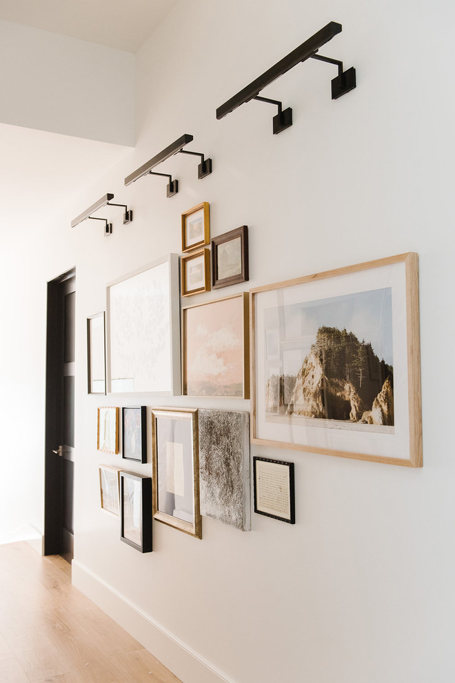 Foto de salón abierto de estilo de casa de campo grande con paredes blancas, suelo de madera clara y pared multimedia
