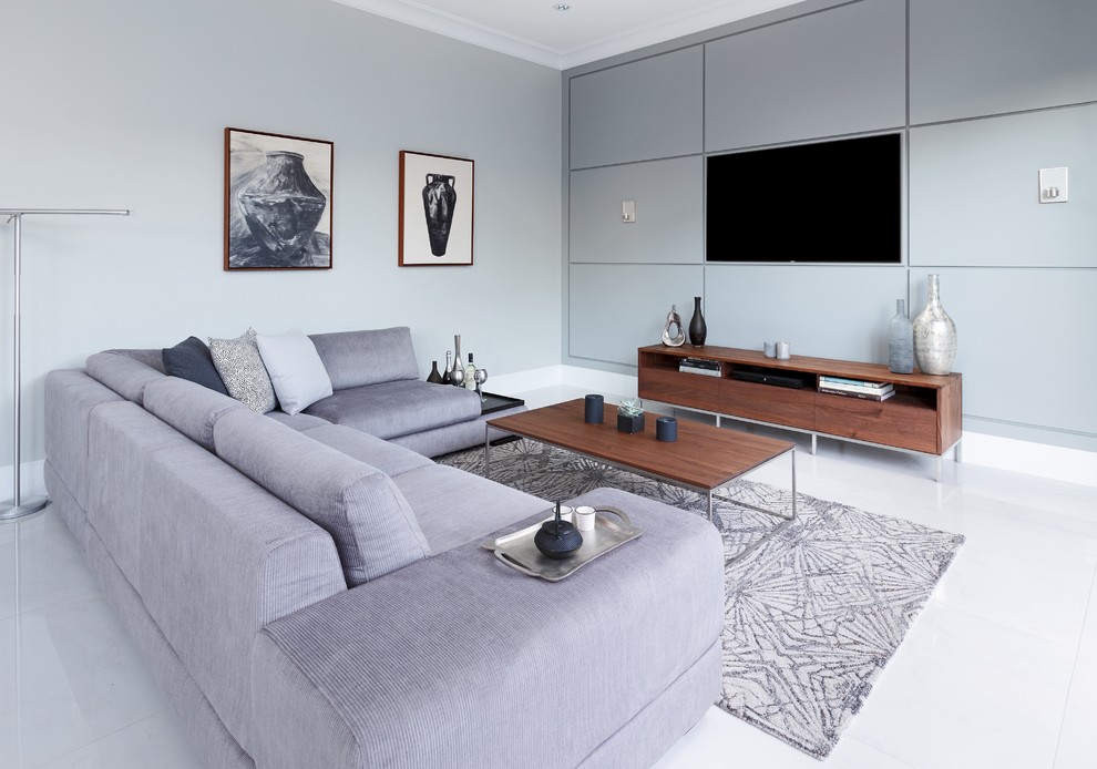 Design ideas for a modern living room in Vancouver with a wall mounted tv, grey walls, white floors and feature lighting.
