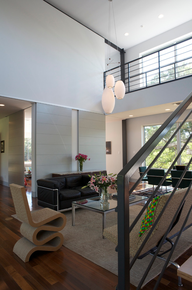 На фото: парадная, открытая гостиная комната среднего размера в стиле модернизм с белыми стенами, паркетным полом среднего тона и бежевым полом без камина, телевизора