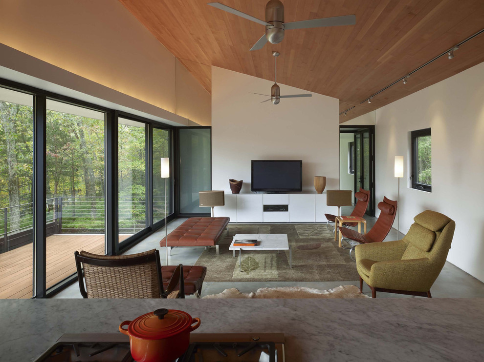 Photo of a modern living room with concrete flooring.